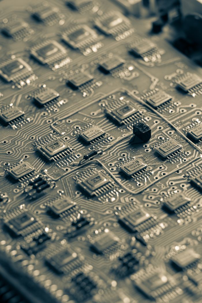 Detailed close-up of a microchip circuit board showcasing intricate electronic patterns.